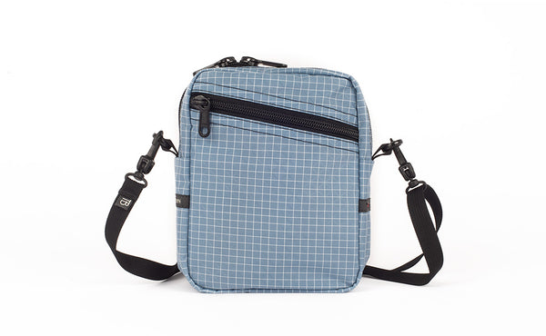 An Everyday Cubelet in Tidal Halcyon (faded blue with a white grid) with a front zipper.